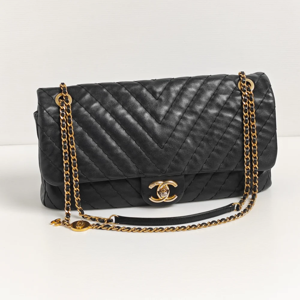 genuine pre-owned Chanel large surpique chevron flap bag